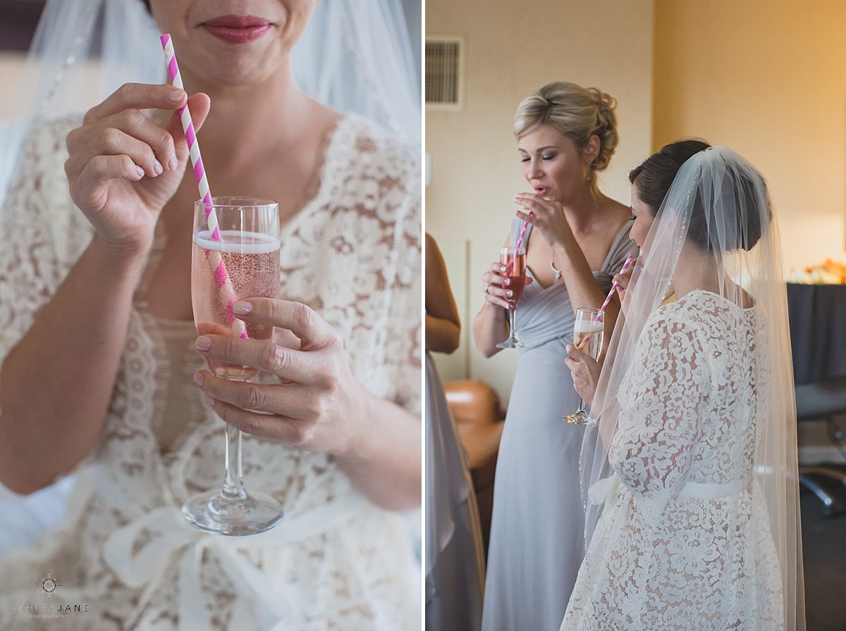 bride drinking rose in a white and pink straw on her wedding day