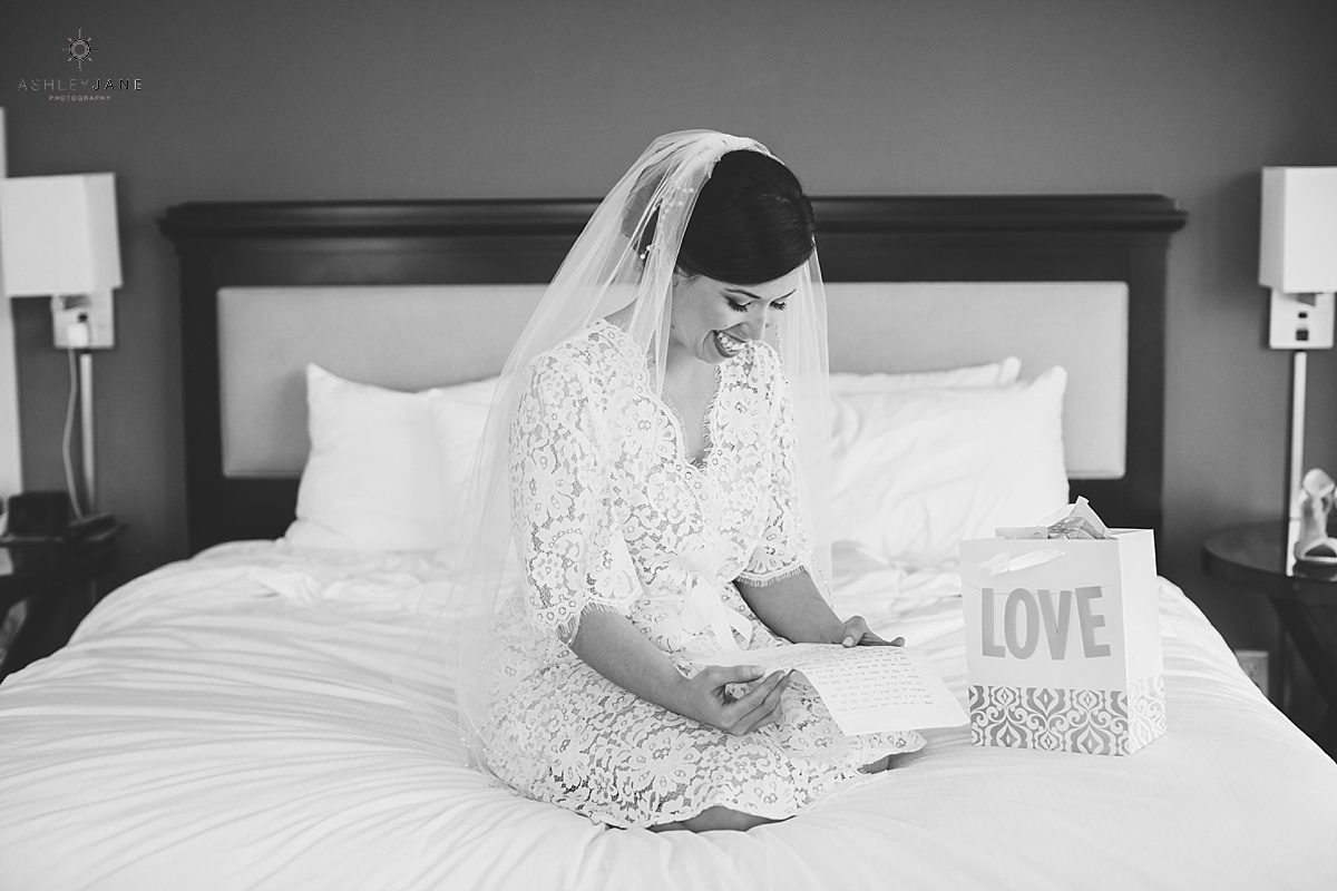 bride getting ready reading a letter from her fiance on her wedding day