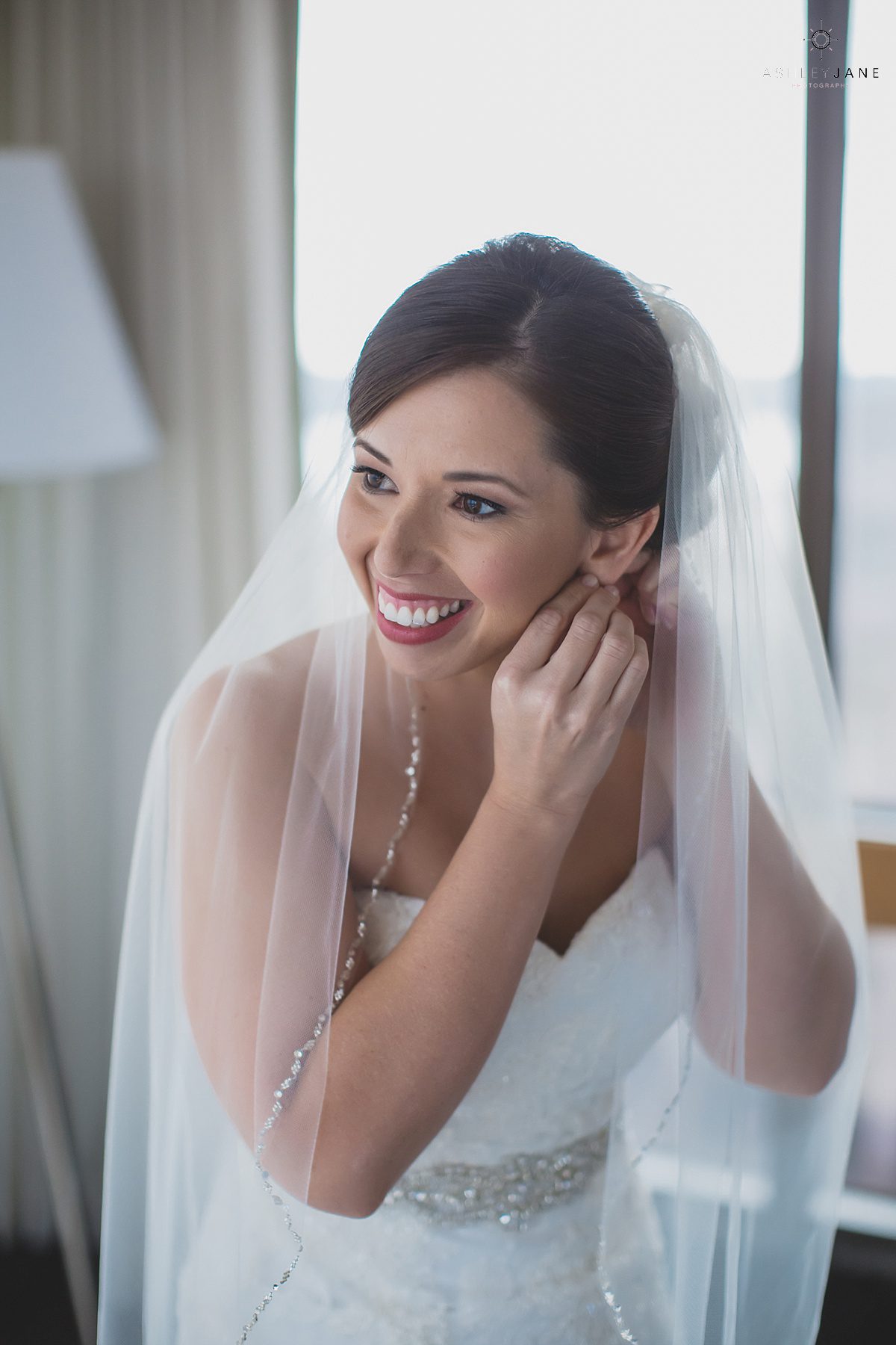 bride putting the finishing touches to her outfit on he wedding day