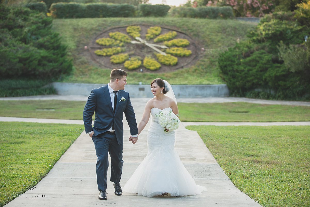 bride and groom outdoor garden holding hands