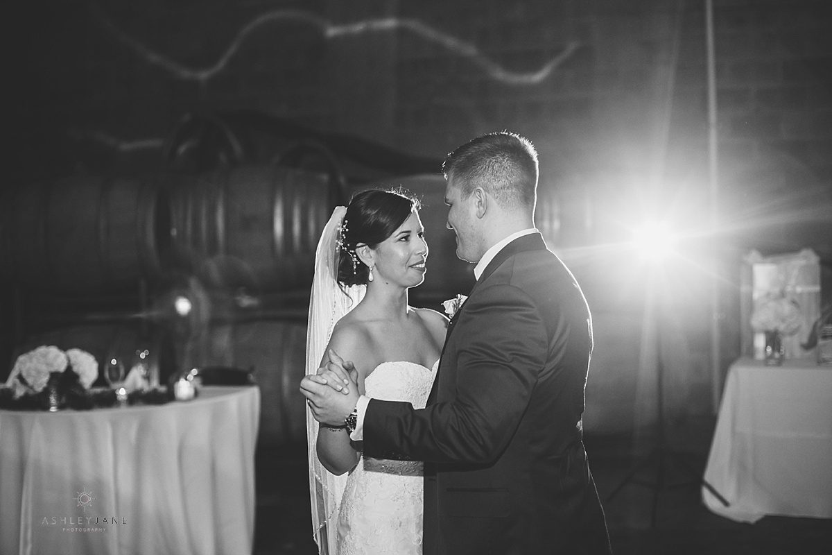 bride and groom first dancing inside winery