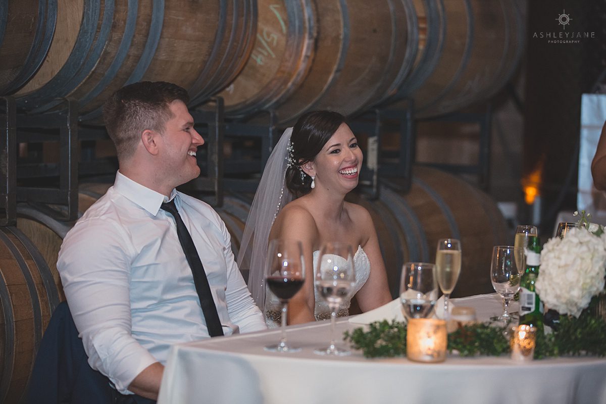 bride and groom laughing during toasts