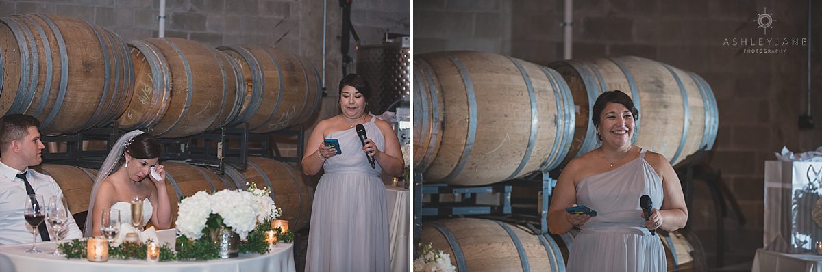 maid of honor giving wedding toast inside rustic winer reception