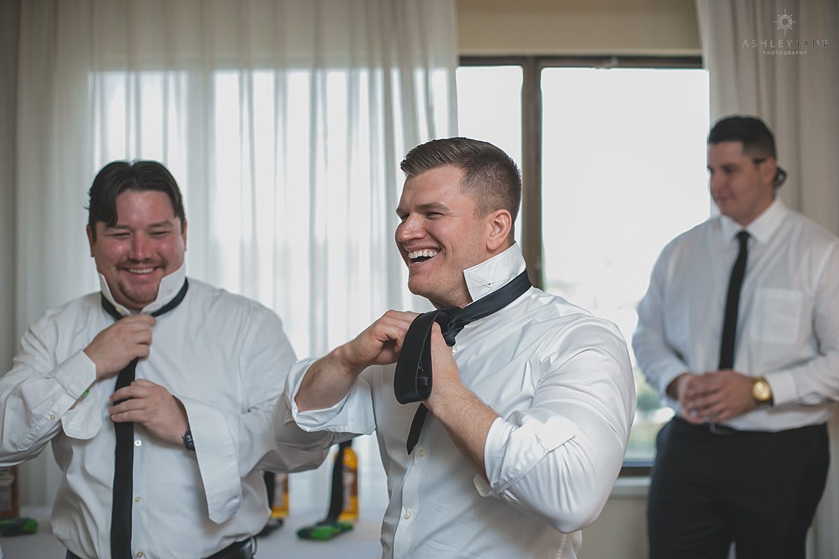 groom getting his tie on on his wedding day