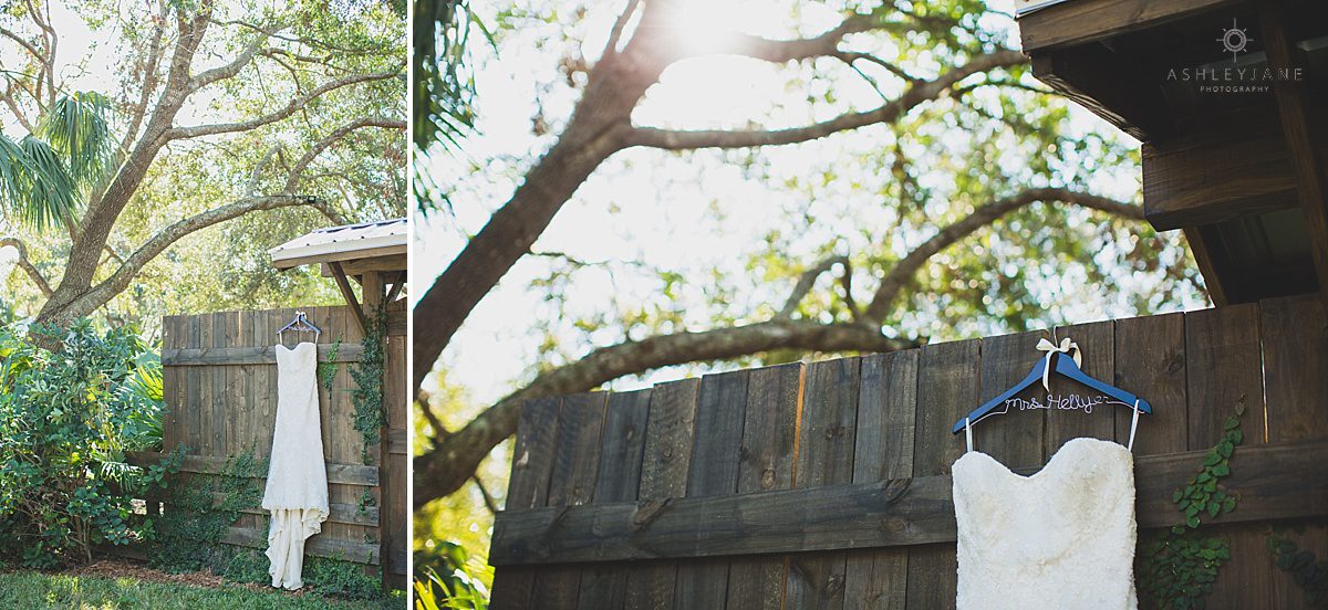 trumpet lace bridal gown hanging in outdoor wedding venue