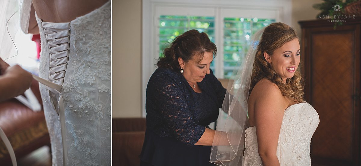 bride getting laced up in her wedding dress by her mother
