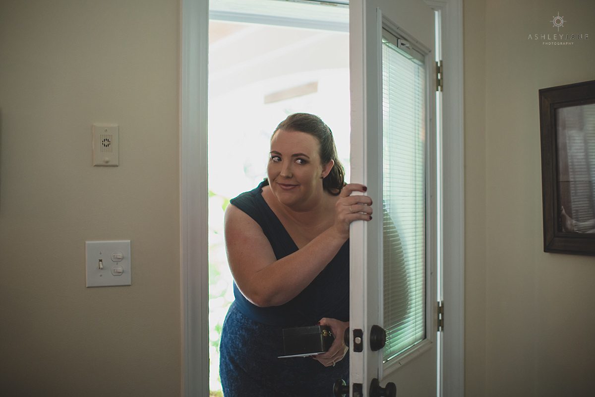 maid of honor delivering surprise gift to groom on his wedding day