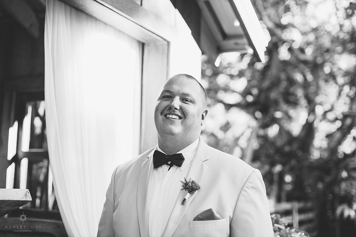 groom smiling at the altar