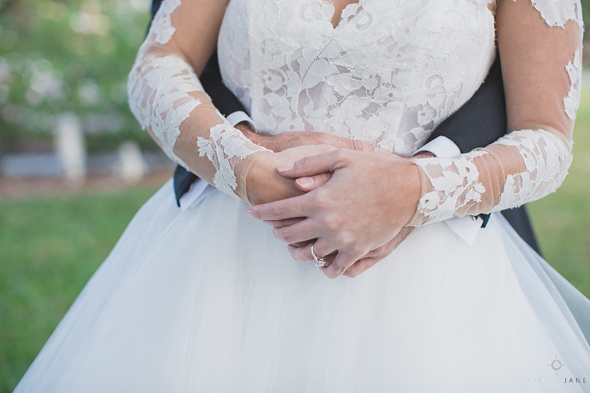 Elegant Rustic Cypress Grove Estate House Wedding | Detail shot of bride and groom holding hands shot caught by orlando wedding photographer
