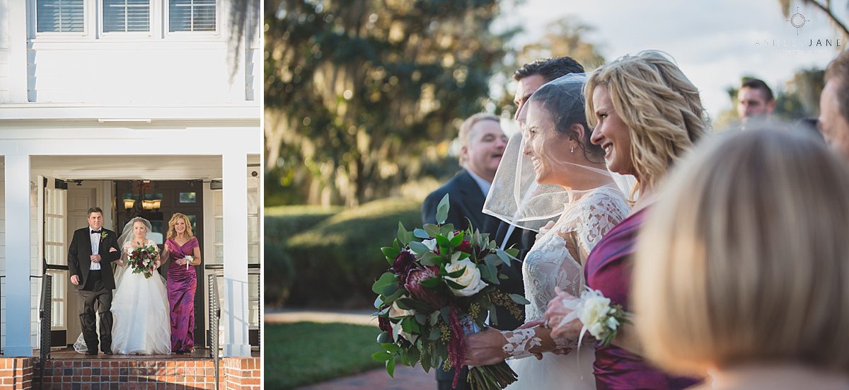 Elegant Rustic Cypress Grove Estate House Wedding | Bride getting walked down the aisle by both parents outdoor wedding wine color bouquet winter wedding florida outdoors cypress grove estate
