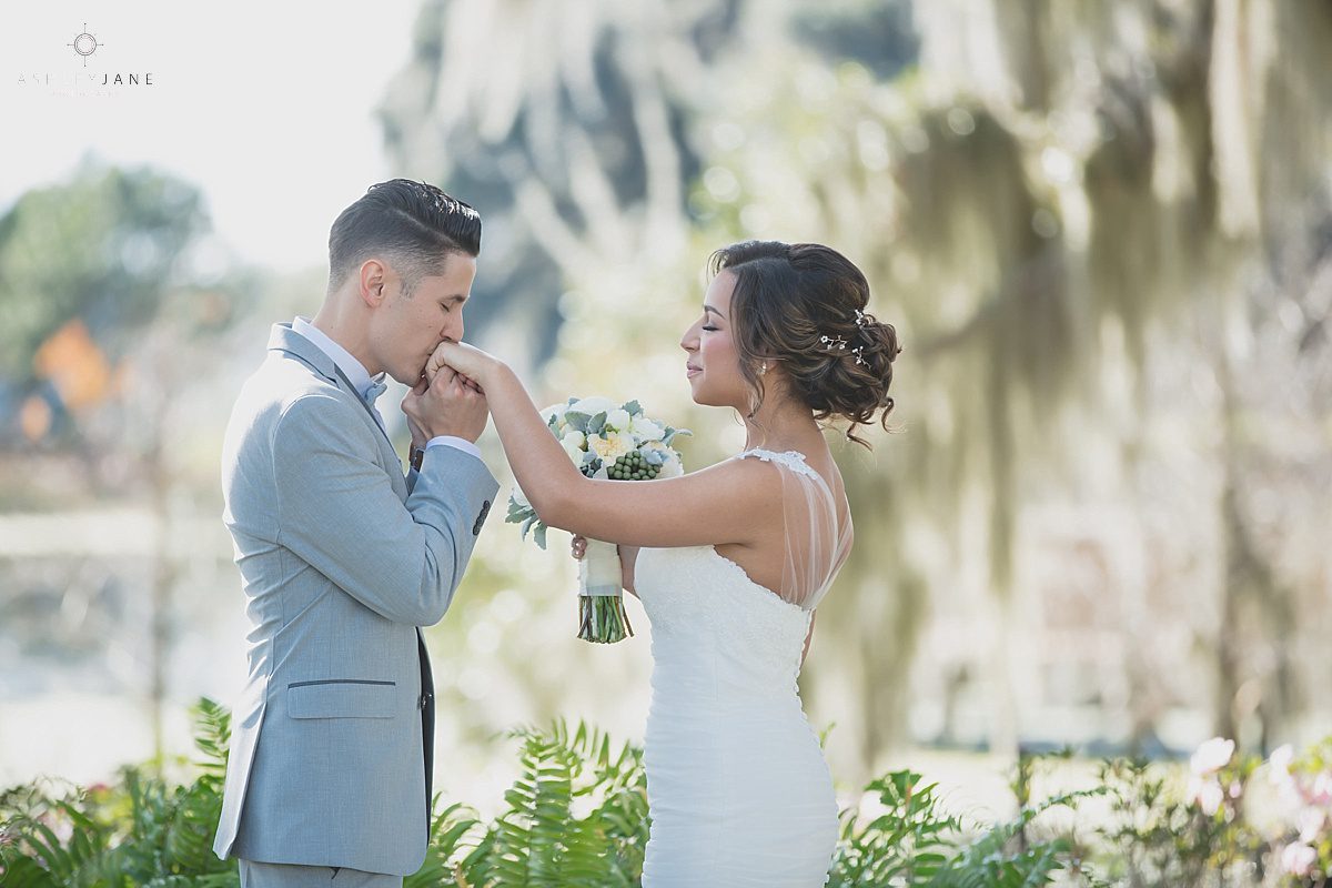 Groom giving his bride a kiss on the hand during an intimate moment of their first look