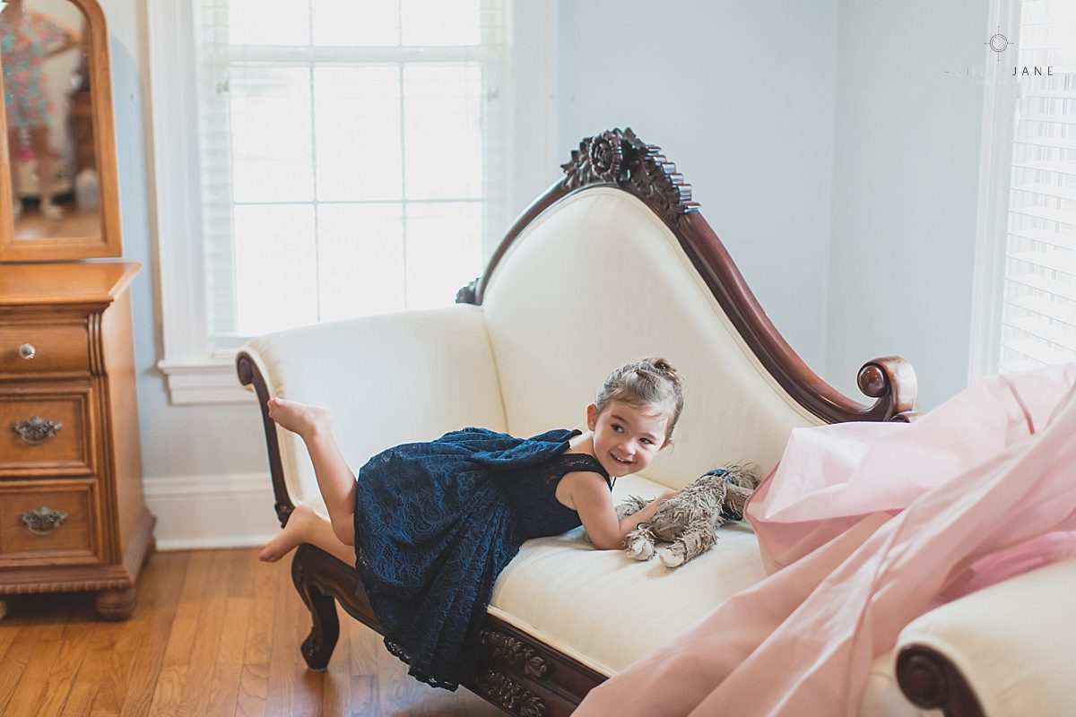 Cute flower girl shot by orlando wedding photographer inside the bridal suite of Cypress Grove Estate House