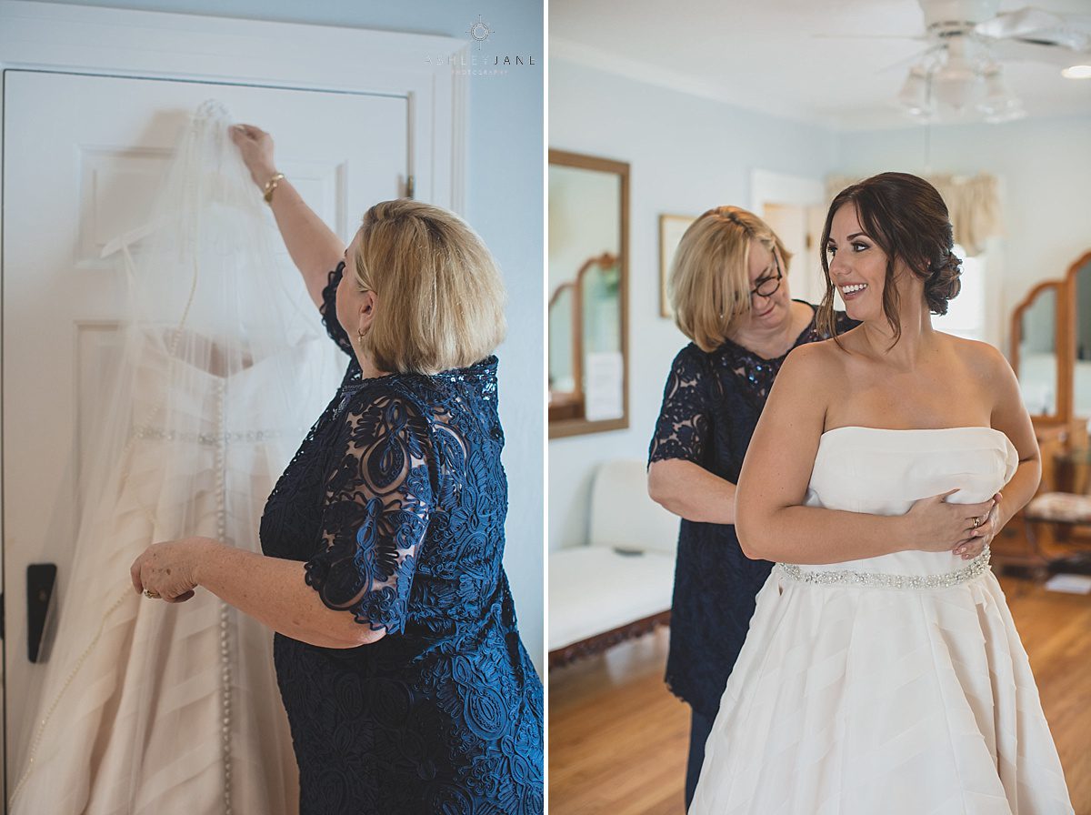 Bride getting dressed by her mother on her wedding day shot by orlando wedding photographer