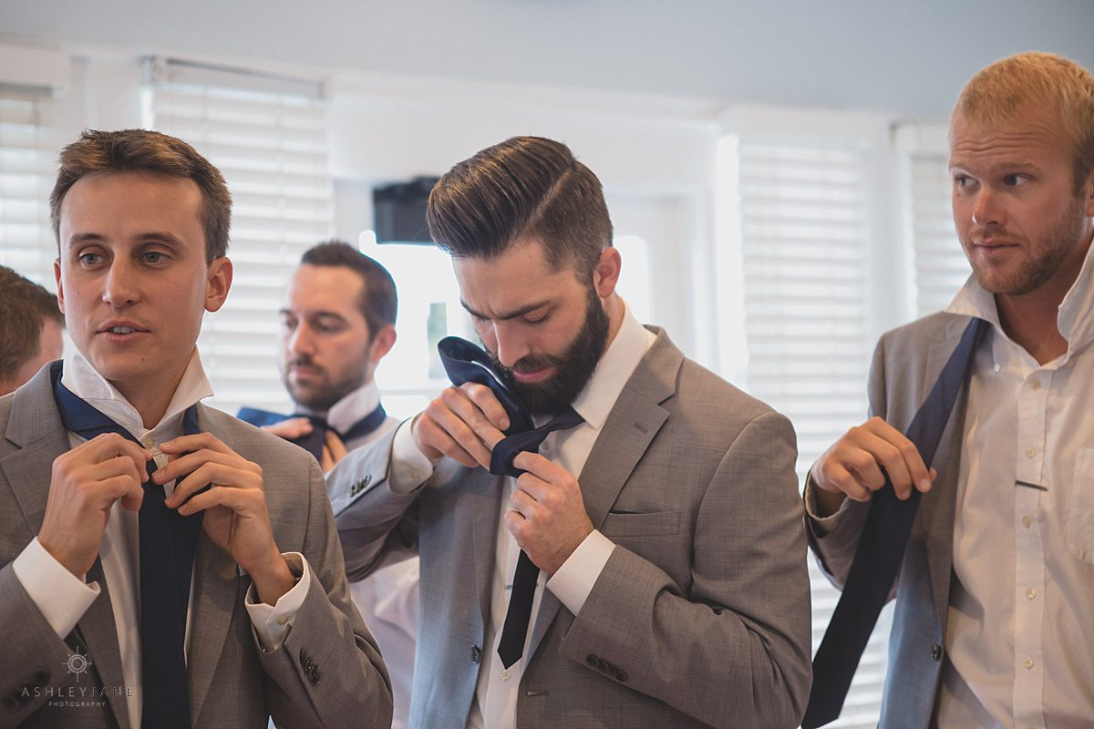 Groomsmen getting dressed to attend Southern Estate House Wedding