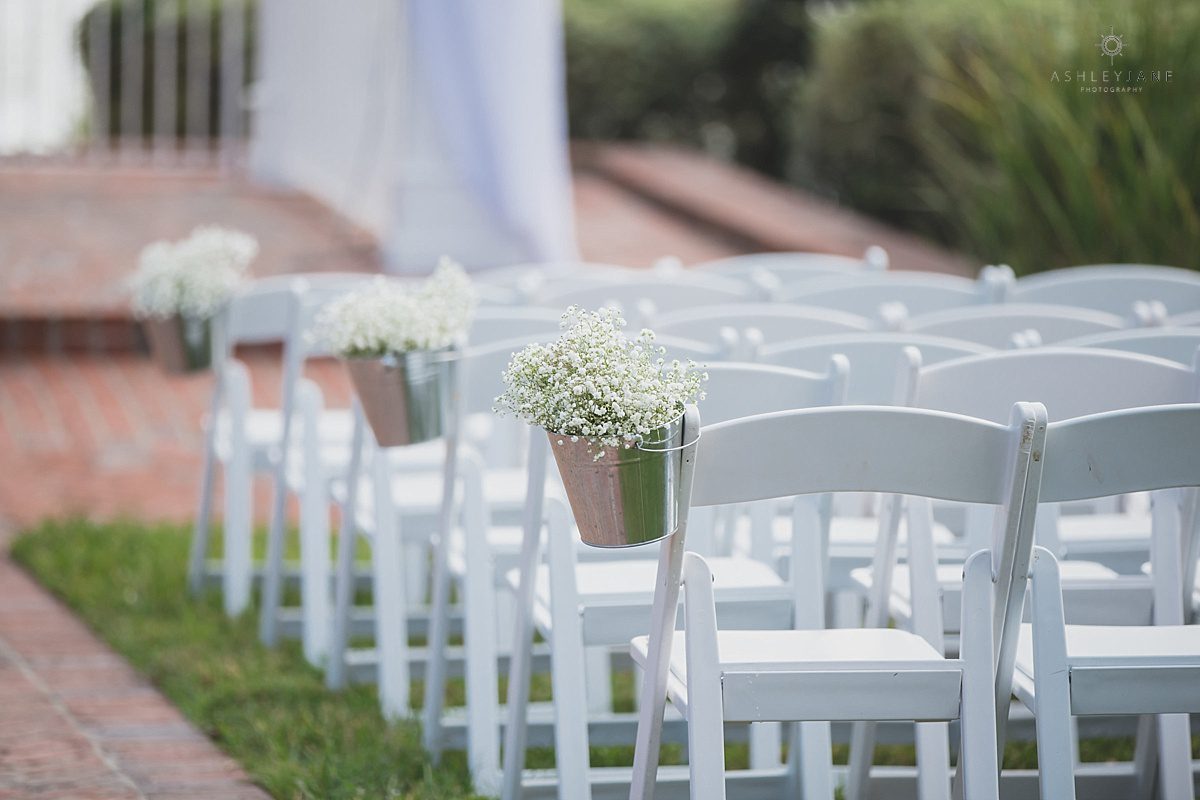 Delicate baby's breath aisle decor in galvanized buckets line the chairs for Southern Estate House Wedding