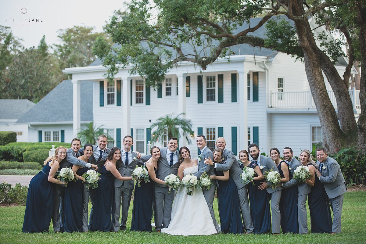 Grey and Navy bridal party outside of Cypress Grove Estate House for their Southern Estate House Wedding shot by orlando wedding photographer