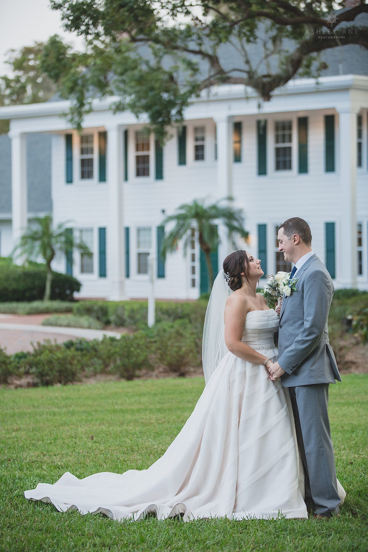 Bride in her classic strapless ivory gown outside of Cypress Grove Estate House with her groom