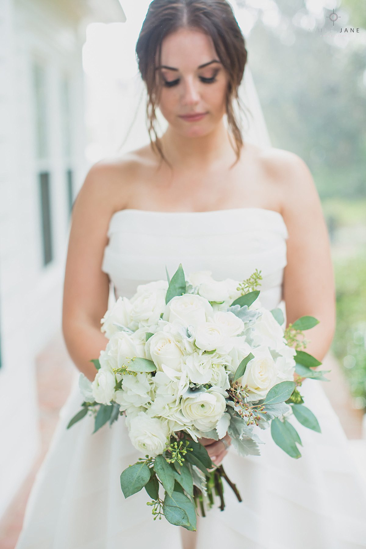 Bride holding her beautiful ivory and dusty blue bridal bouquet at Southern Estate House Wedding shot by orlando wedding photographer 