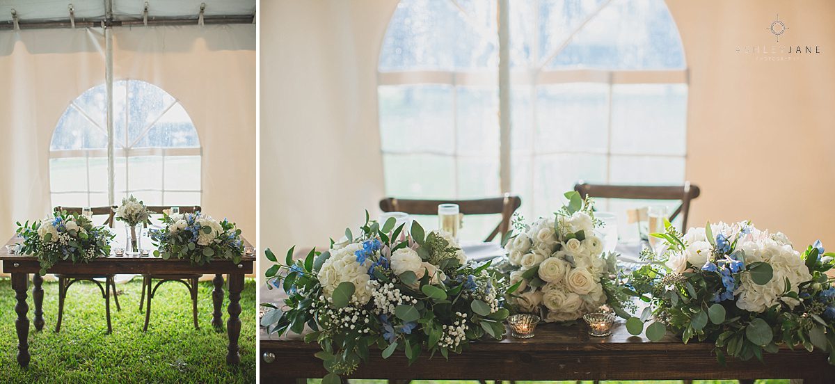 Rustic ivory floral sweetheart table under tent of grand lawn on Cypress Grove Estate House 
