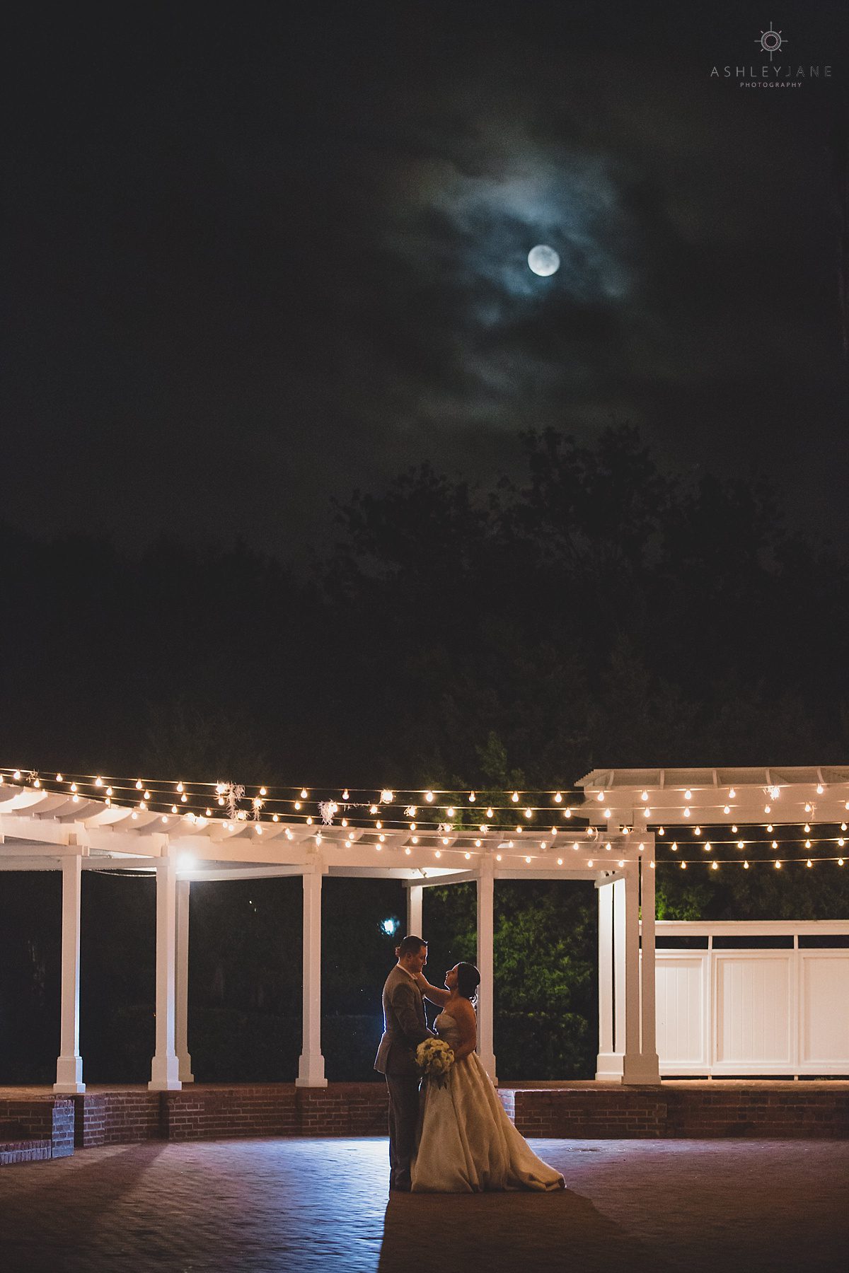 Bride and groom share a last dance under a full moon of their Southern Estate House Wedding shot by Orlando wedding photographer