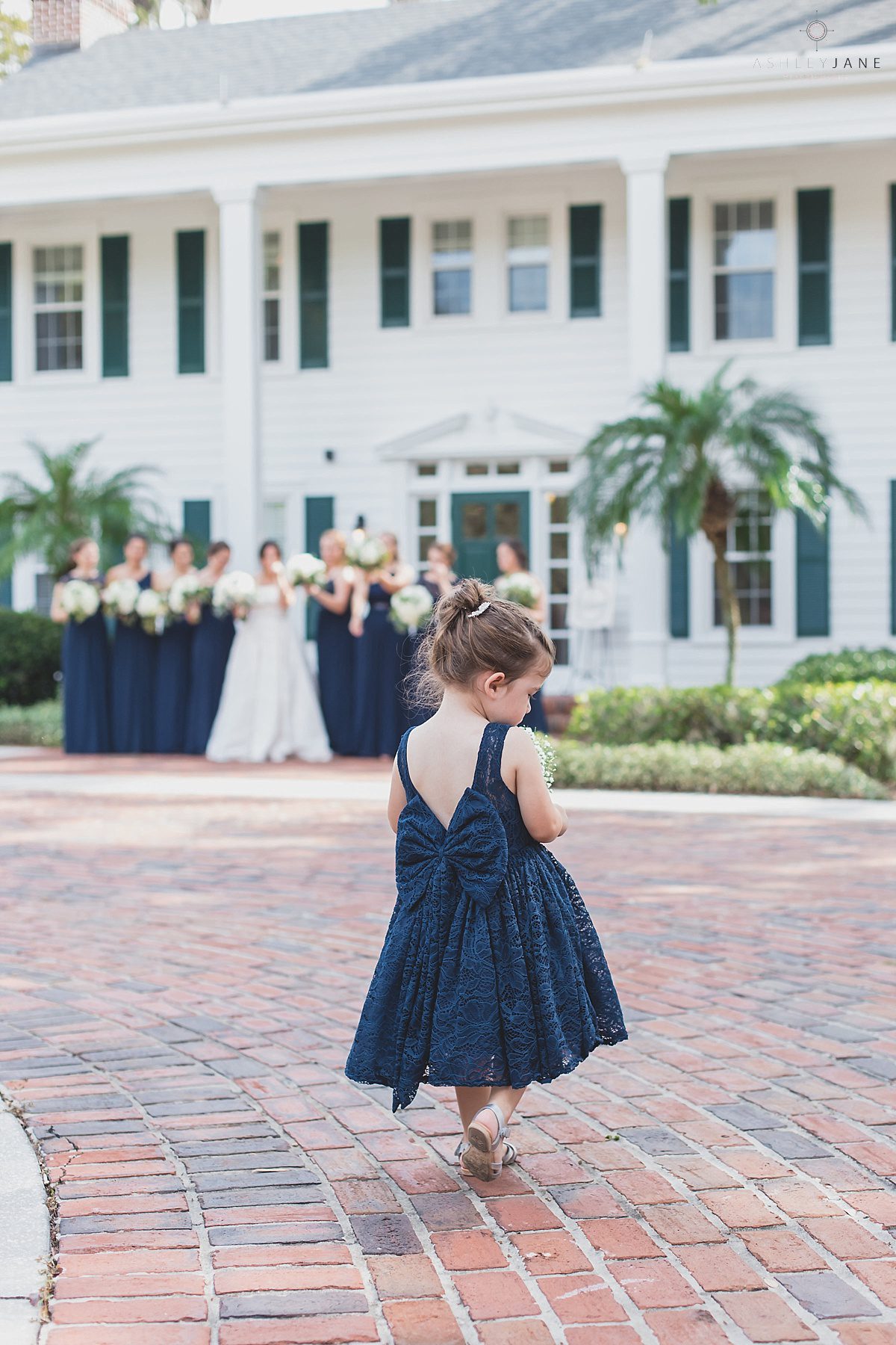 Adorable navy blue flower girl for Southern Estate House Wedding shot by orlando wedding photograher