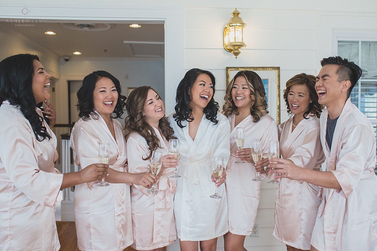 Bridesmaids and bride toasting champagne while getting ready caught by orlando wedding photographer inside the bridal suite of Cypress Grove Estate House