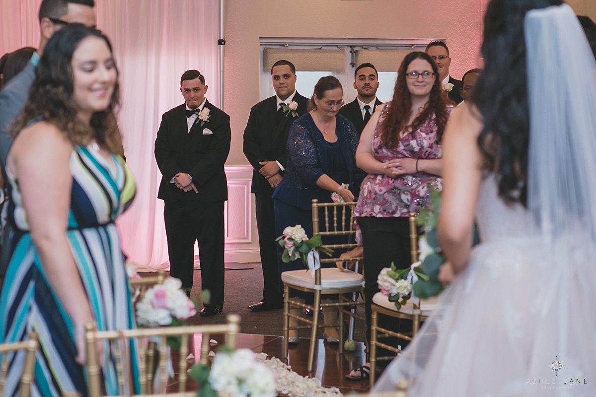 Romantic Blush Royal Crest Room Wedding | Groom waiting at the altar while the bride walks down the aisle