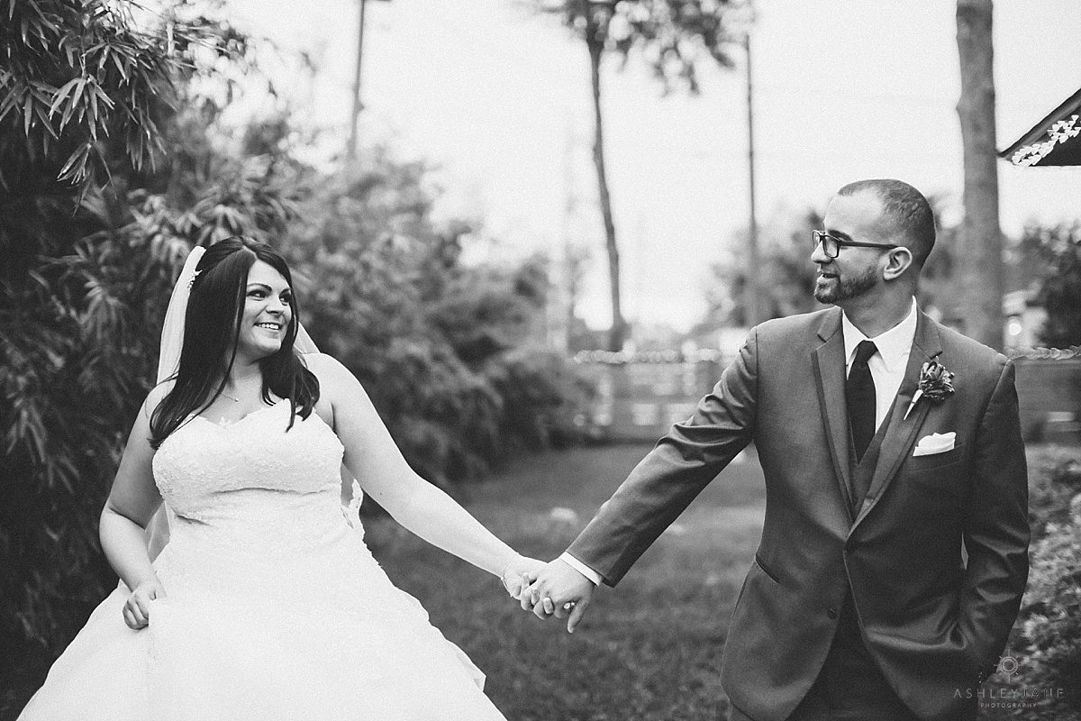 Black and White shot of bride and groom holding hands a the acre shot by orlando wedding photographer