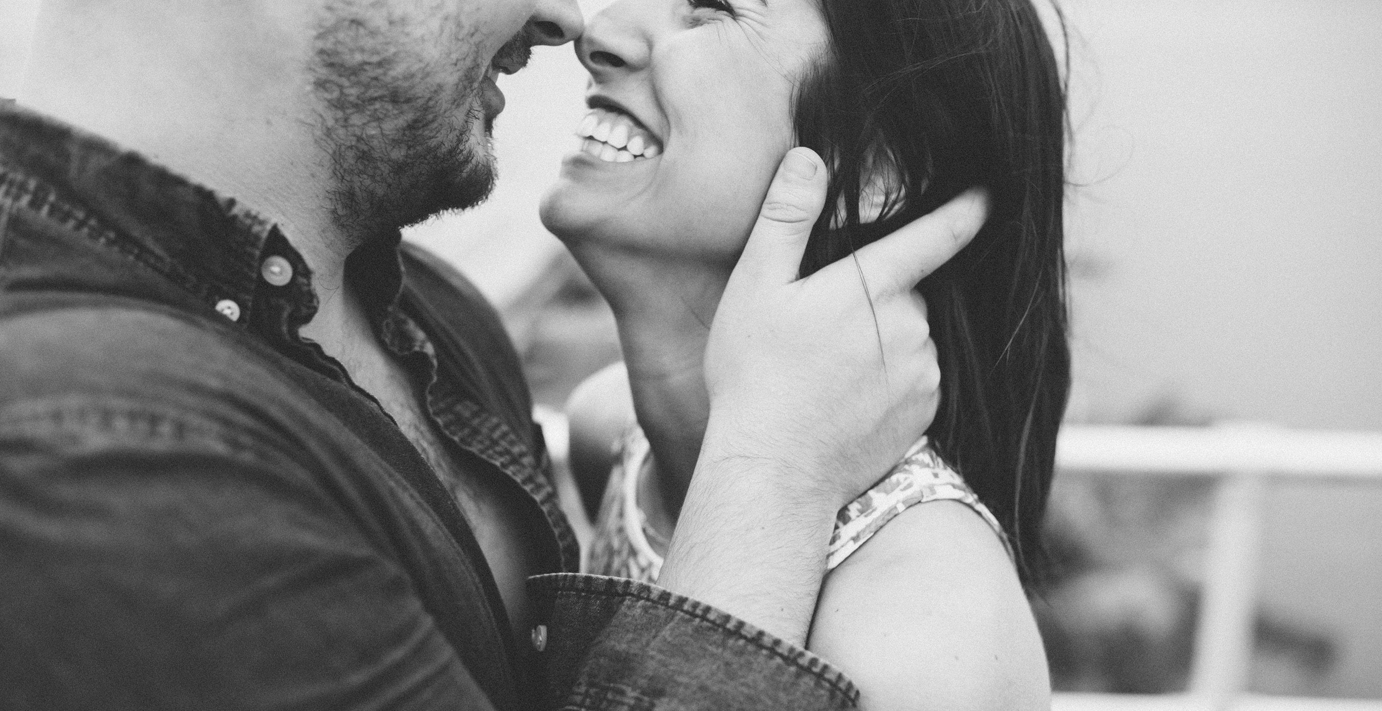 Young couple holding each other close and smiling during engagement shoot in Ponce Inlet. Shot by Orlando Wedding Photographer.
