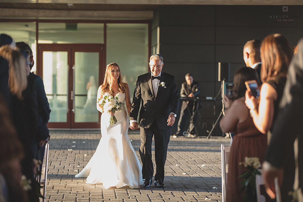 Bride walking down the aisle with her father at the Clubhouse at Streamsong Red shot by orlando wedding photographer