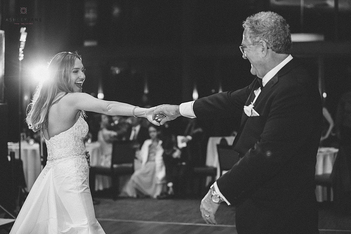 Bride dancing with her father during her classic champagne and blush wedding shot by orlando wedding photographer