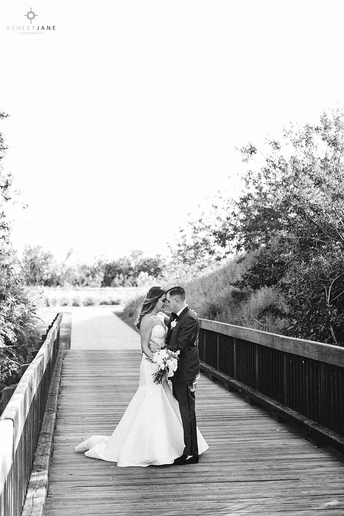 Bride and groom getting cozy during their portraits shot by orlando wedding photographer