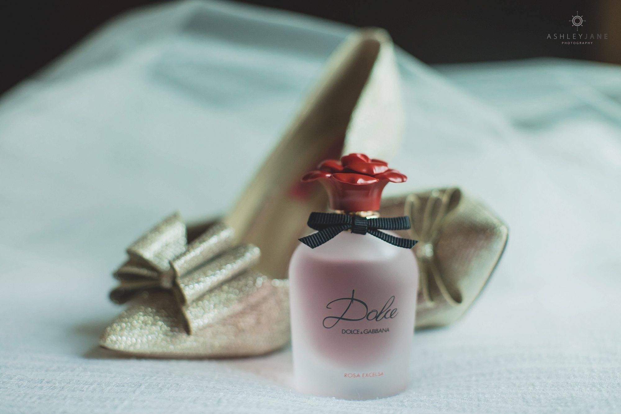 A detail shot of the brides shoes and perfume. Photo taken at Royal Crest Room by Orlando wedding photographer.